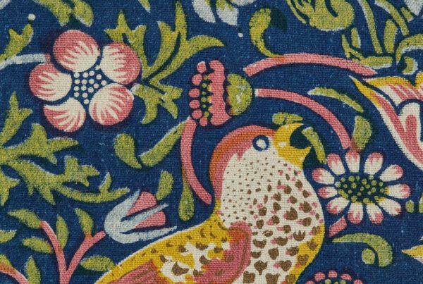 A close up of a sample of William Morris' famous Strawberry Thief design. This shot shows a thrush with an open beak.