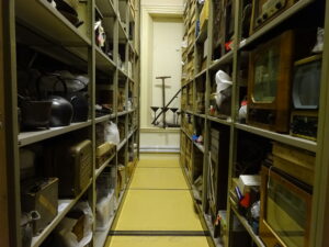A walkway between shelves in Tullie's stores, where objects not on display are kept and cared for.