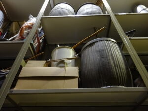 Old laundry equipment in the Tullie stores including a dolly tub, mops and possers (sticks used for stirring clothes in a wash tub).