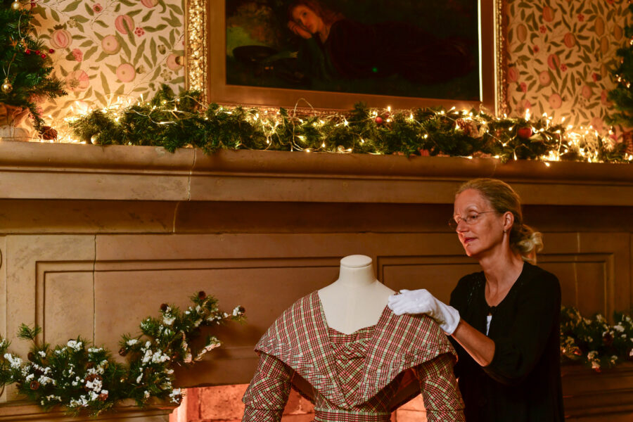 Melanie Gardner, Fine and Decorative Arts Curator at Tullie preparing an item of costume for display.